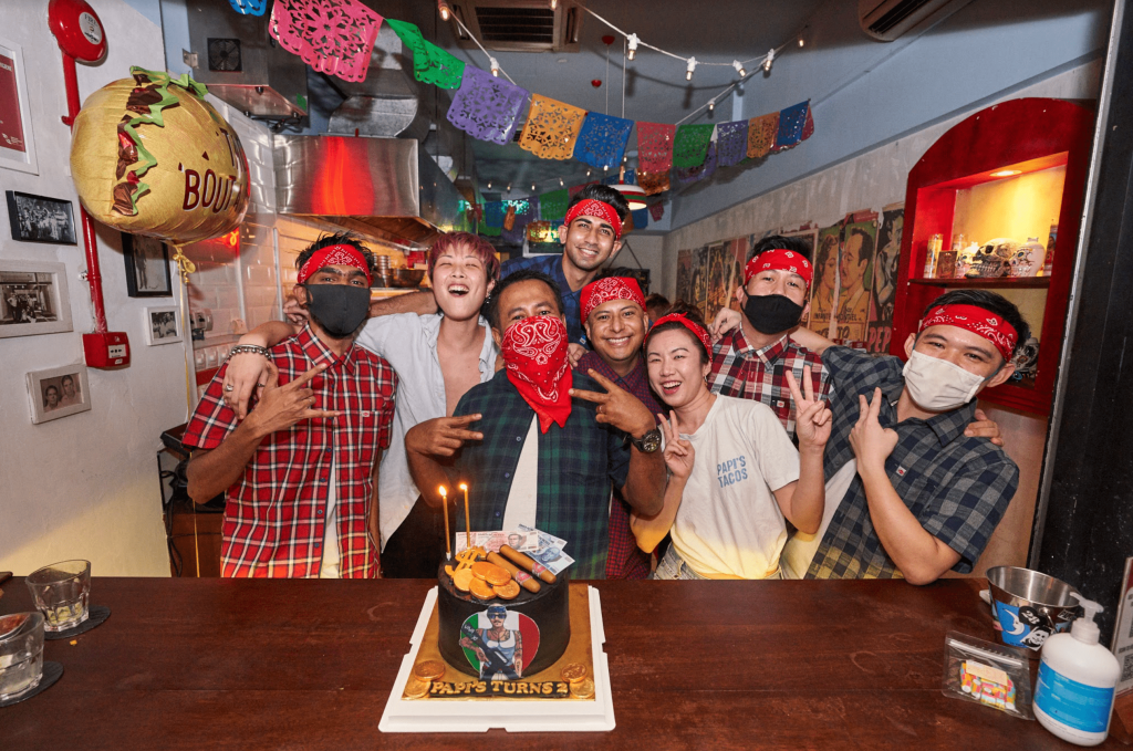 Papi's Tacos celebrating an event with a cake