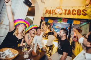 People pointing to Papi's Tacos