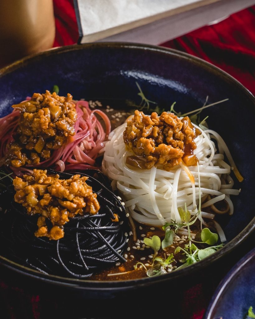 Close-up of an artfully presented bowl of three types of noodles
