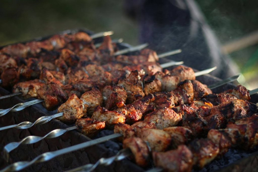 picture of a bunch of satay is being grilled