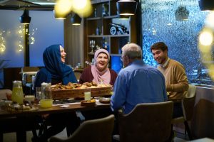 a muslim family having dinner at a restaurant