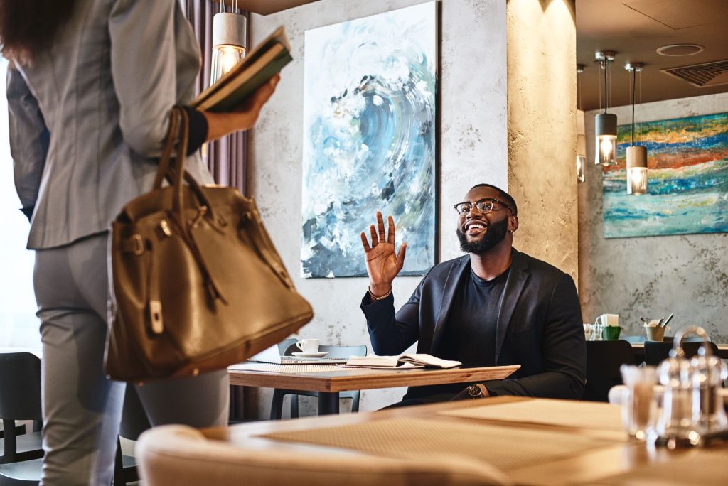 a man greeting his date that has just arrived in the restaurant