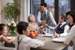 a waiter serving a table full with people